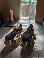 Pair of Power quad skates front view on floor