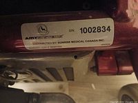 Close-up of AmySystems label with serial number on wheelchair frame