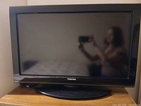 Front view of Toshiba 32C120U TV on stand