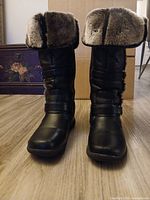 Front view of both boots showing faux fur cuffs and toe scuffs