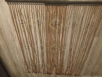 Front view of full bead curtain hung on wall