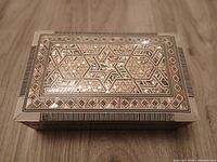 Top view of closed box showing full geometric mother of pearl inlay pattern