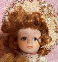Close-up of doll face, hair, bonnet detail