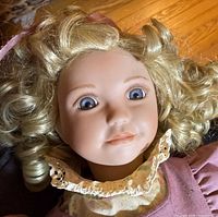 Close-up of doll face showing hair, eyes, dress bodice
