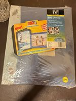 Front view of sealed album with 400-photo sleeve packaging and boxed mailer frames visible