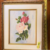 Front view of framed rose painting with measuring tape showing size