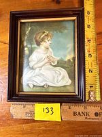 Front view of framed print with ruler for scale