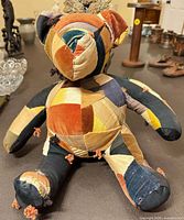 Full back and side view of patchwork teddy bear on table