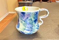 Front view of multicolor stoneware mug