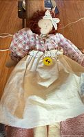 Full view of rag doll showing clothing, missing arm, scale reference