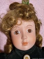Close-up of doll head showing porcelain face, hair, eye detail