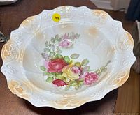 Top view showing full bowl with floral interior and gold-beige scalloped rim