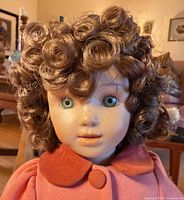 Close-up head showing porcelain face, glass eyes, wig
