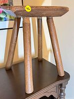 Full view of stool on table showing legs and seat