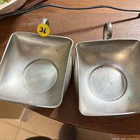 Top view of both aluminum square dishes showing size, shape, patina