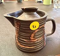 Front view of pitcher showing glaze and lid