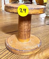 Full view of wooden spool bobbin upright