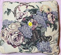 Front of pillow showing floral tapestry design