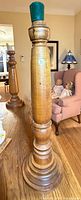 Full view of turned wooden candlestick on table