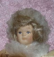Close-up of doll head showing painted facial features and hair