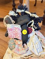 Group shot of large rag doll with two smaller dolls on lap