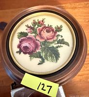 Front view of framed petit point showing full rose design and frame details