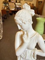 Close-up profile of figurine head and torso