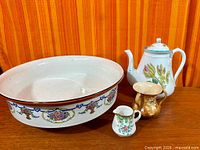 Group shot of basin, teapot, mini creamer, small vase