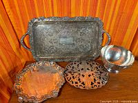 All four silver-plate pieces grouped