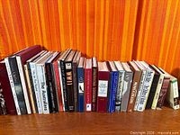 Shelf of approximately 34 assorted books