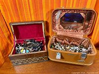 Wooden and vinyl jewelry boxes closed and open showing jewellery
