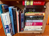 Full view of box showing assorted books standing and stacked
