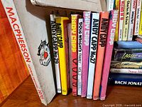 Front row showing Macpherson book and Andy Capp paperbacks