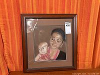 Full view of framed artwork showing mother and child portrait