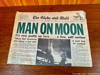 Front page showing headline "MAN ON MOON" and photo of lunar module