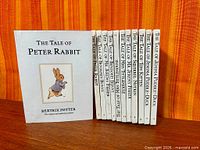 Front cover of The Tale of Peter Rabbit with row of additional Potter books