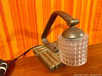 Side view of brassed desk lamp showing shade and base