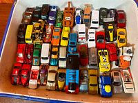 Overall view of tray containing assortment of diecast cars and trucks