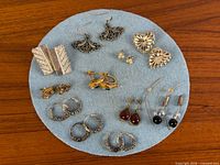 Full view of all earring pairs on felt pad