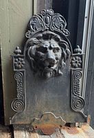Front view showing entire cast iron back plate and lion head