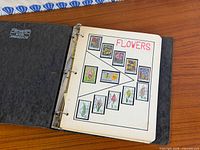 Binder open showing flower-themed stamp page