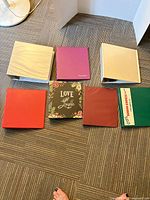 Eight assorted binders laid out showing colour variety