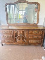 Front view of dresser with mirror showing overall style and drawer configuration