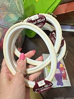 Three ivory oval Flexi-Hoop embroidery hoops stacked together
