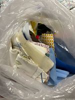 assorted fabric pieces and trim inside clear bag