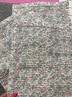Two of the floral cotton placemats showing pintuck panel and overall pattern