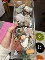 top view of clear bin filled with assorted stones