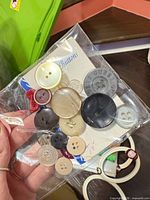 Front view of bag showing variety of button sizes and colors