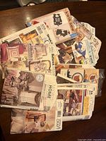 Stack of mixed sewing patterns on table