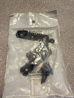 Front of sealed package showing latch parts